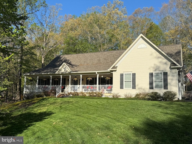 view of front of home with a porch, a shingled roof, and a front lawn
