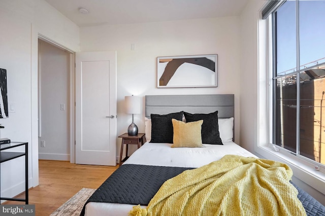 bedroom with baseboards and wood finished floors