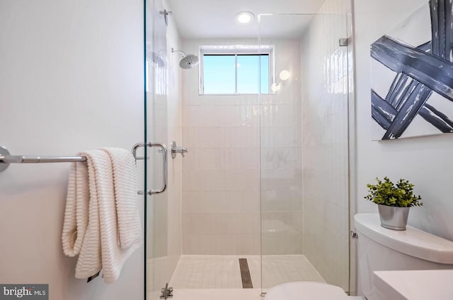 full bath featuring toilet and a stall shower