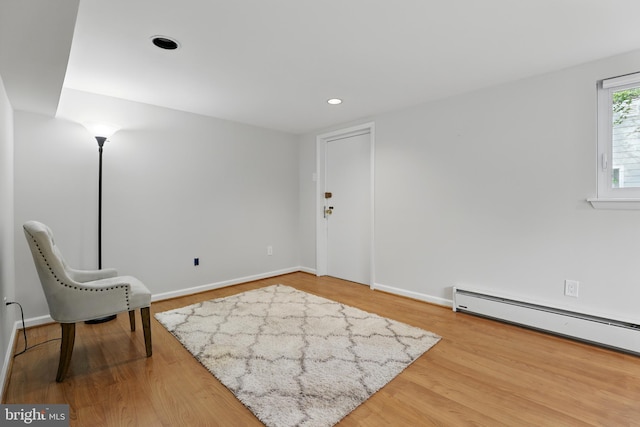 unfurnished room with baseboards, recessed lighting, wood finished floors, and a baseboard heating unit