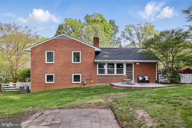 rear view of house featuring a patio, brick siding, fence, and central AC