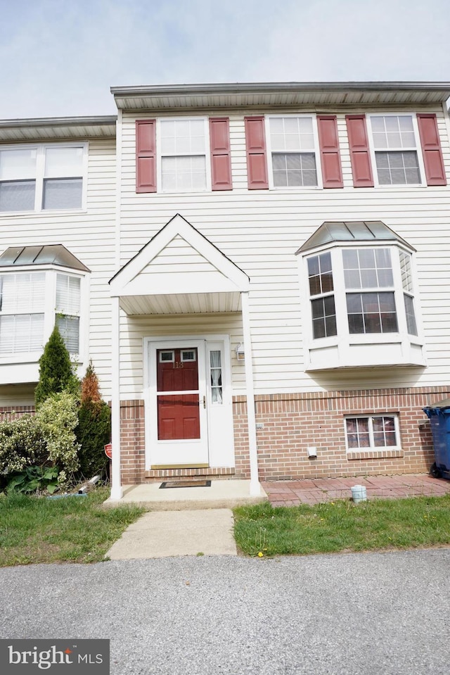 view of property featuring brick siding