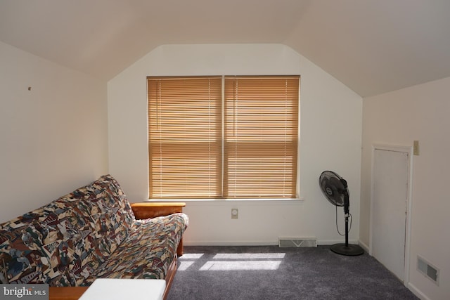 living area with visible vents, carpet flooring, and vaulted ceiling