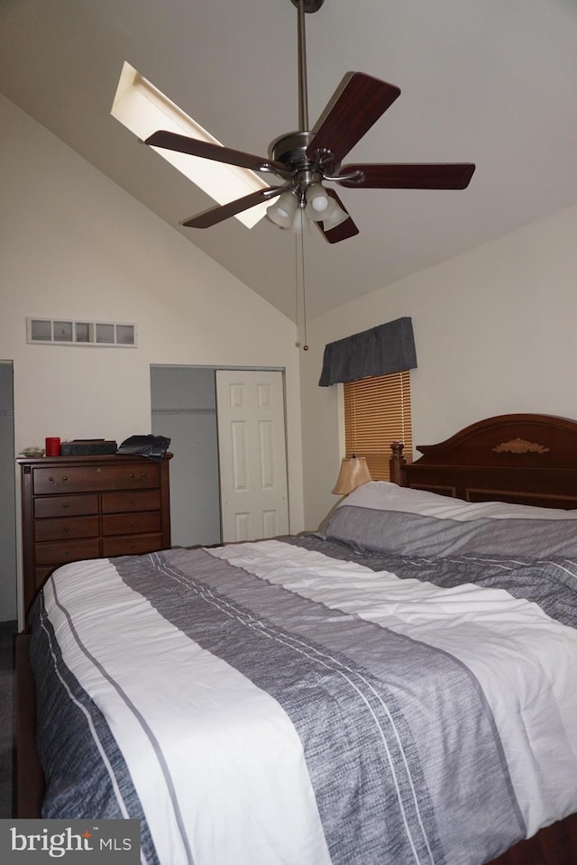 bedroom with a closet, a ceiling fan, lofted ceiling, and visible vents