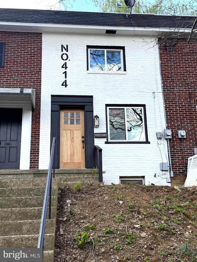 entrance to property with brick siding