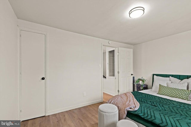 bedroom featuring light wood-style flooring and baseboards