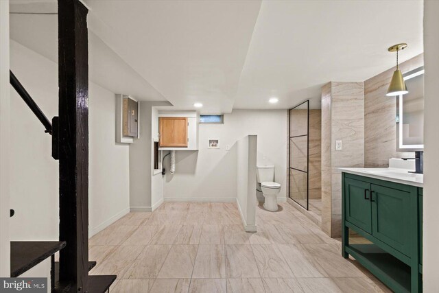 interior space with baseboards, a sink, and recessed lighting