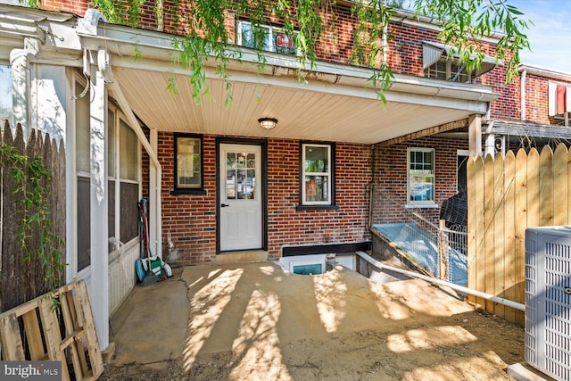 doorway to property with brick siding