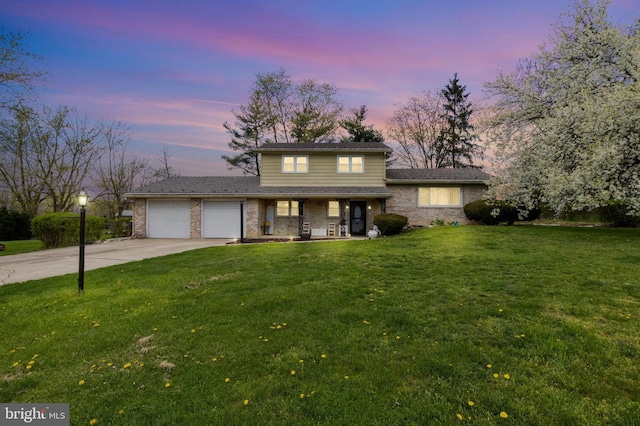 6 Shover Dr, Carlisle, PA 17013 - traditional home with concrete driveway, an attached garage, covered porch, brick siding, and a front yard