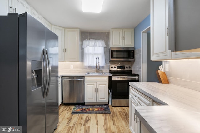 6 Shover Dr, Carlisle, PA 17013 - kitchen featuring light countertops, a sink, light wood-style floors, and appliances with stainless steel finishes