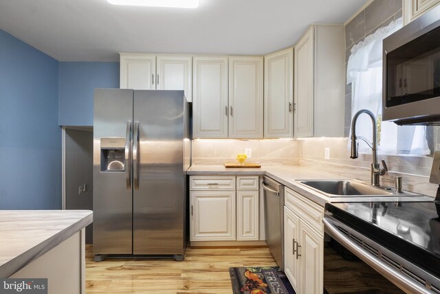 6 Shover Dr, Carlisle, PA 17013 - kitchen with a sink, tasteful backsplash, light wood-style floors, light countertops, and appliances with stainless steel finishes