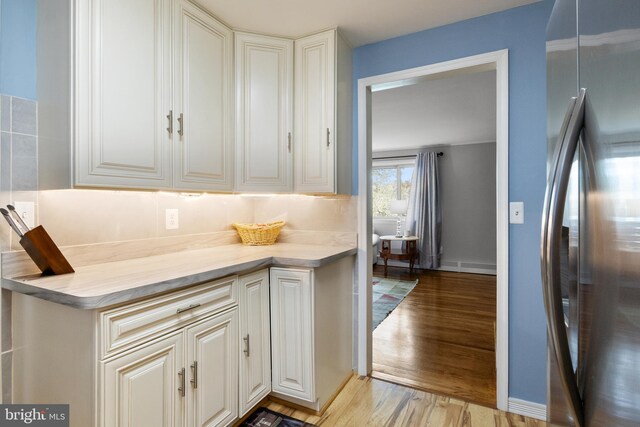 6 Shover Dr, Carlisle, PA 17013 - kitchen featuring light wood-type flooring, light countertops, freestanding refrigerator, and white cabinetry