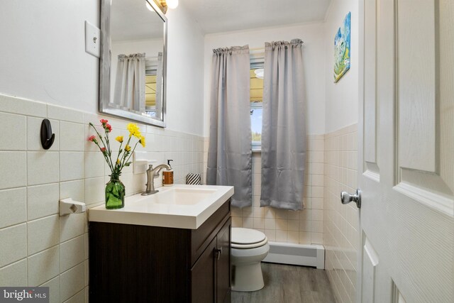 6 Shover Dr, Carlisle, PA 17013 - bathroom featuring toilet, tile walls, baseboard heating, wood finished floors, and vanity