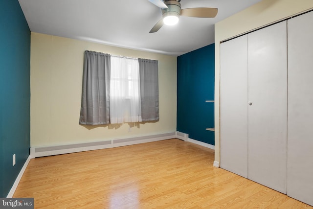 6 Shover Dr, Carlisle, PA 17013 - unfurnished bedroom with a baseboard radiator, wood finished floors, a closet, ceiling fan, and baseboards