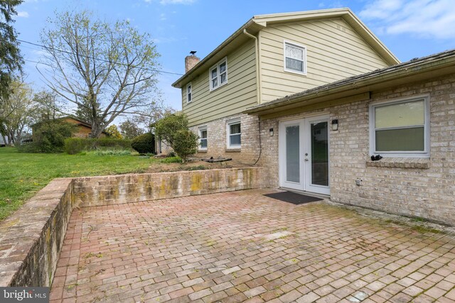 6 Shover Dr, Carlisle, PA 17013 - back of house with a chimney, a yard, french doors, a patio, and brick siding