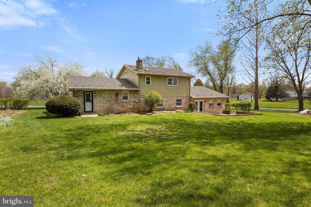 6 Shover Dr, Carlisle, PA 17013 - back of house featuring a chimney, brick siding, and a yard