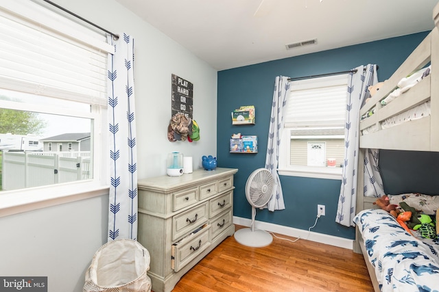 bedroom featuring visible vents, baseboards, and light wood-type flooring