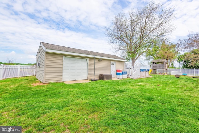 exterior space with an outdoor structure, a fenced backyard, and a garage