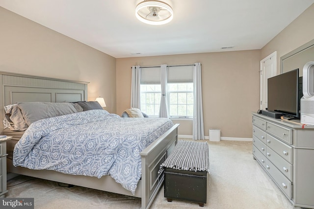 bedroom featuring visible vents, baseboards, and light colored carpet