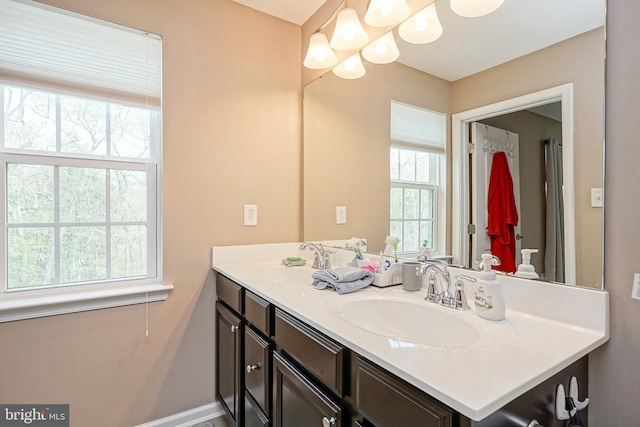 bathroom featuring vanity and baseboards