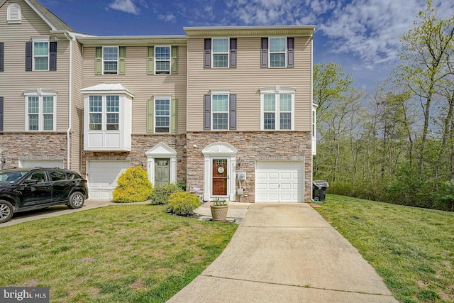townhome / multi-family property featuring an attached garage, driveway, stone siding, and a front lawn