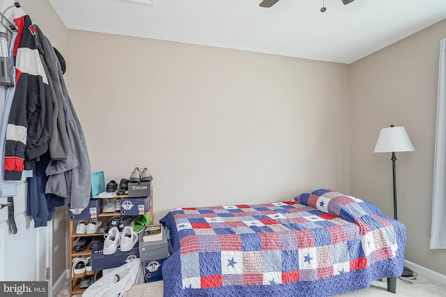 bedroom with baseboards, a ceiling fan, and carpet