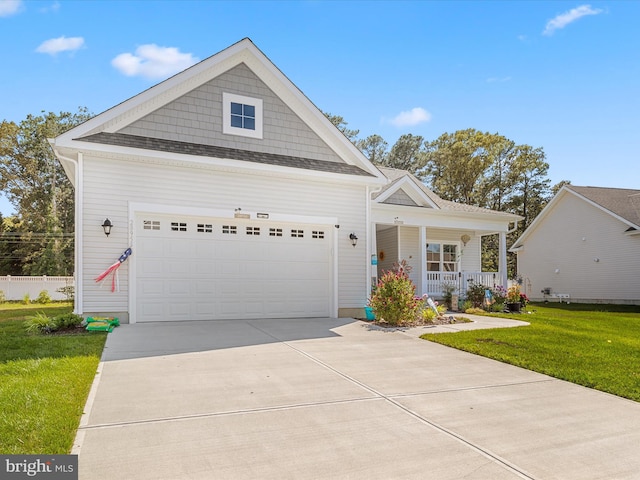 craftsman-style home with a porch, an attached garage, a front lawn, and driveway