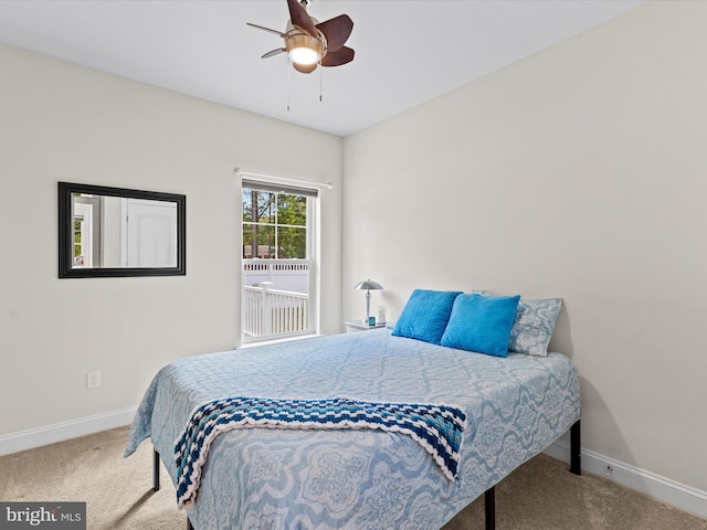 carpeted bedroom featuring baseboards and ceiling fan