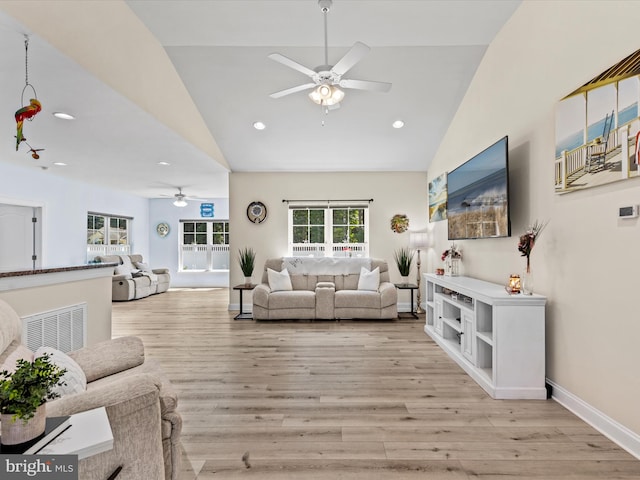 living room with high vaulted ceiling, ceiling fan, recessed lighting, and light wood-type flooring