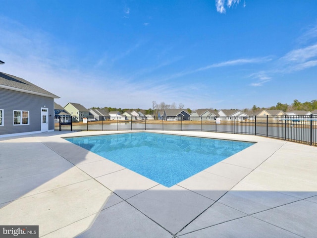 view of pool featuring a residential view, a fenced in pool, a patio, and fence