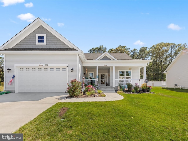 craftsman-style home featuring driveway, a porch, a front yard, and a garage