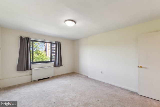 carpeted empty room with radiator
