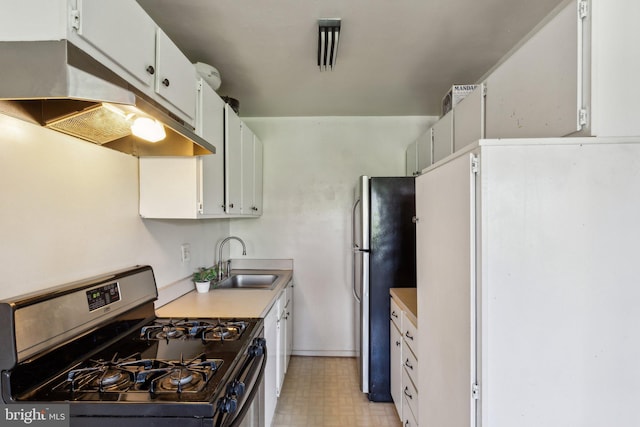 kitchen with stainless steel appliances, under cabinet range hood, light countertops, white cabinets, and a sink