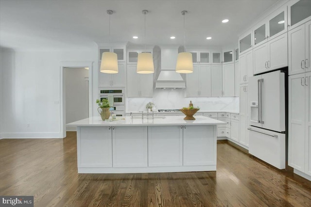 kitchen with white cabinets, white appliances, light countertops, premium range hood, and baseboards
