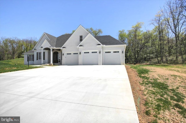 view of front of property featuring concrete driveway, an attached garage, and a front yard