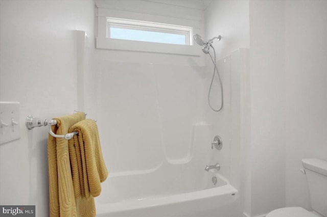 bathroom featuring shower / bathing tub combination and toilet