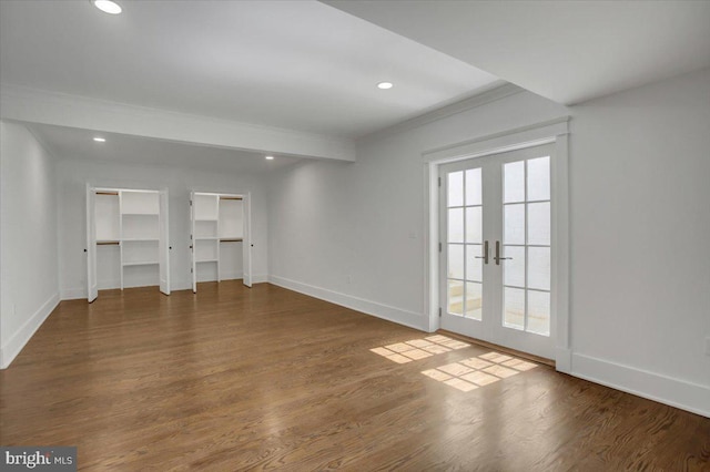 unfurnished bedroom with baseboards, recessed lighting, wood finished floors, and french doors