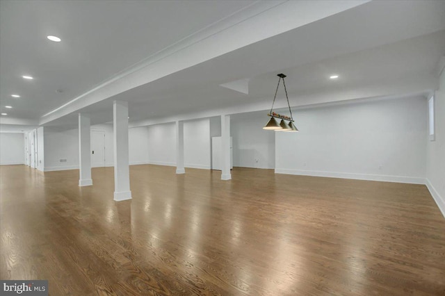 finished below grade area with recessed lighting, baseboards, and wood finished floors