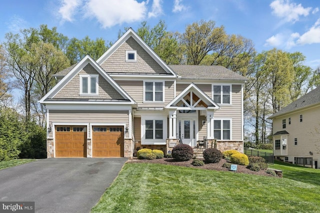 craftsman inspired home featuring a garage, stone siding, driveway, and a front yard