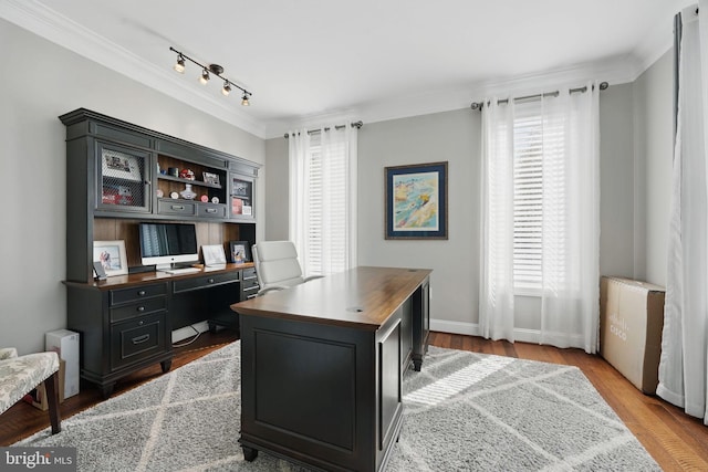 office with crown molding, rail lighting, wood finished floors, and a healthy amount of sunlight