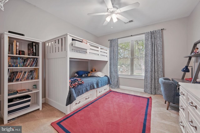 bedroom with a ceiling fan, baseboards, visible vents, and light carpet