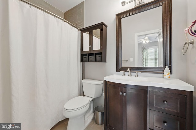 bathroom with toilet, ceiling fan, tile patterned flooring, and vanity