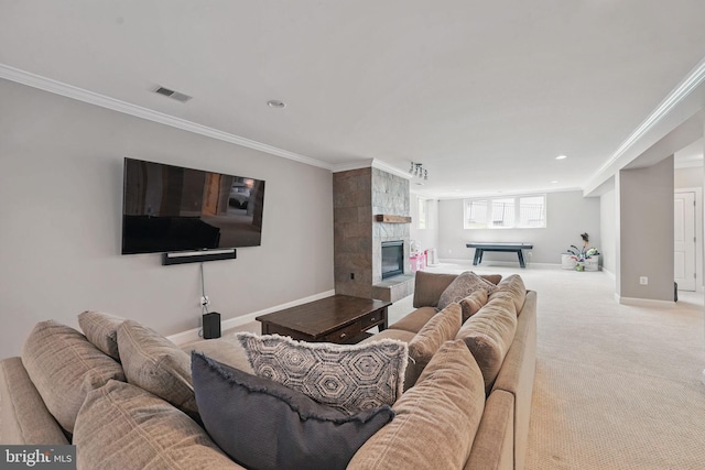 carpeted living room featuring visible vents, crown molding, a fireplace, baseboards, and recessed lighting