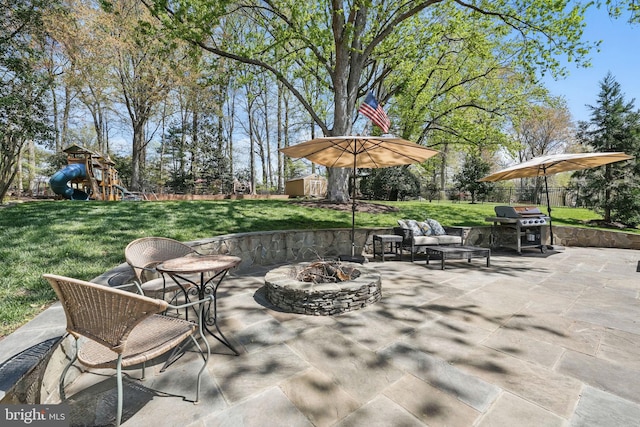 view of patio / terrace featuring a playground, fence, a grill, and an outdoor living space with a fire pit