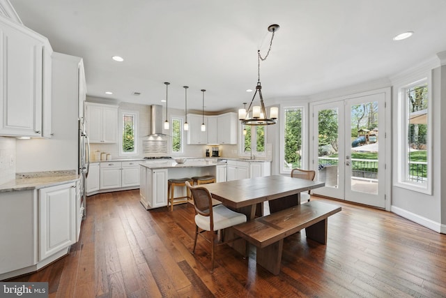 dining space featuring recessed lighting, a notable chandelier, and dark wood-style floors
