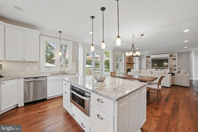 10008 Murnane St, Vienna, VA 22181 - kitchen featuring dark wood-type flooring, decorative backsplash, a sink, and stainless steel appliances