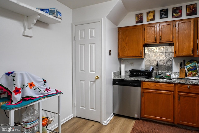 19142 Highstream Dr Unit 679, Germantown, MD 20874 - kitchen with brown cabinets, a sink, dishwasher, dark stone counters, and wood finished floors