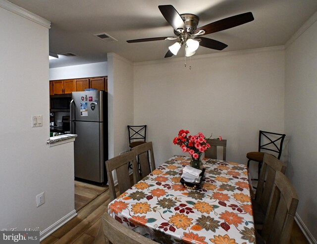 19142 Highstream Dr Unit 679, Germantown, MD 20874 - dining room with visible vents, ornamental molding, ceiling fan, and wood finished floors
