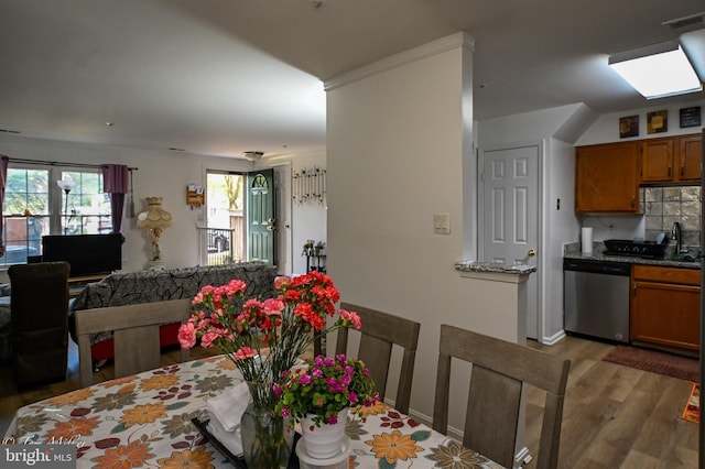 19142 Highstream Dr Unit 679, Germantown, MD 20874 - kitchen with brown cabinetry, visible vents, dishwasher, open floor plan, and light wood-style flooring