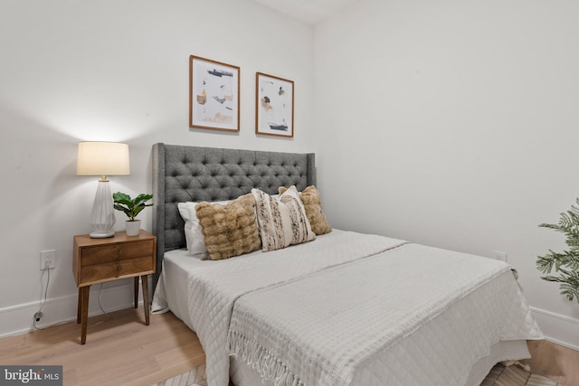 bedroom with wood finished floors and baseboards
